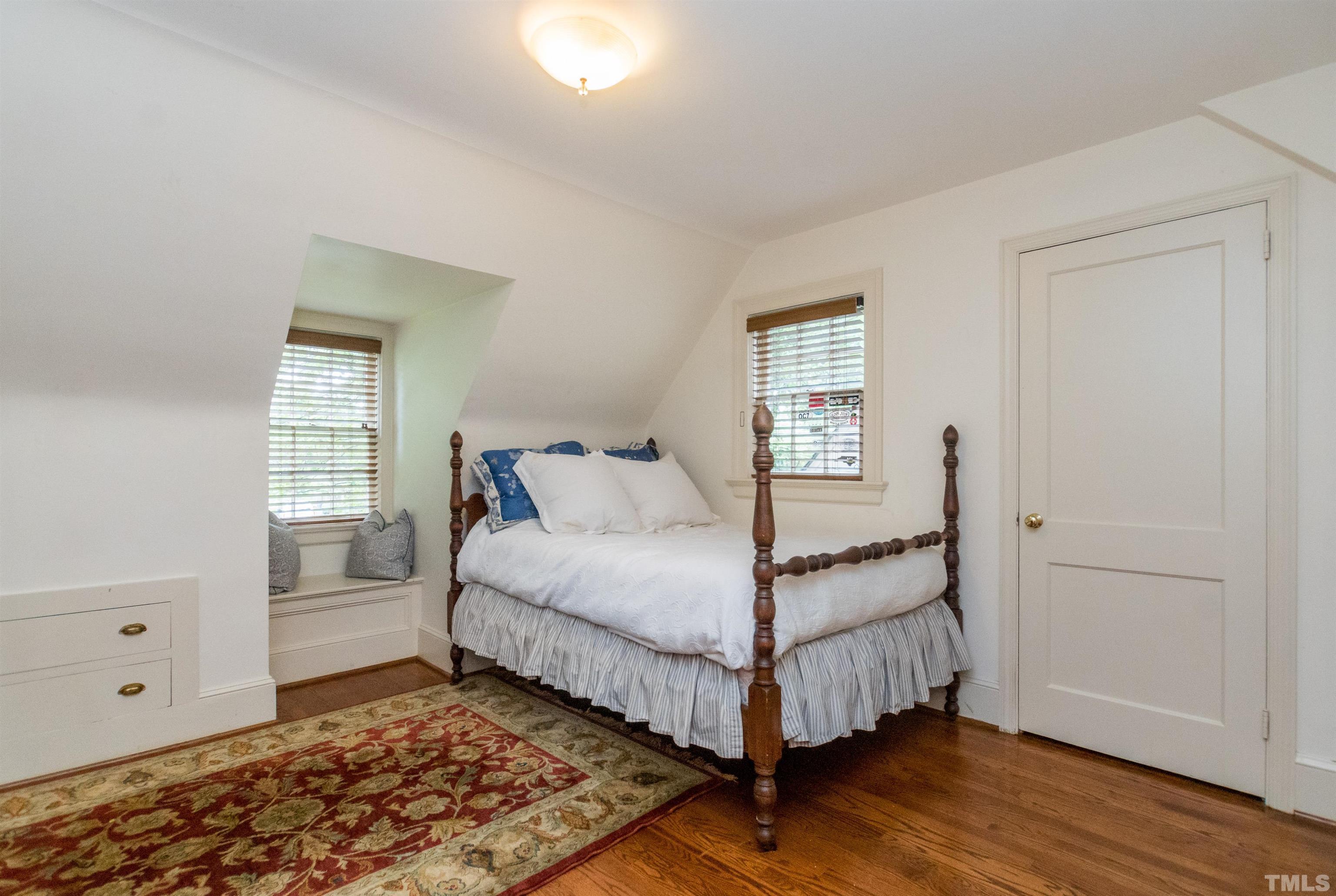 2601 London Drive Raleigh, NC 27608 - Photo 23 of 30 a bedroom with a bed and wooden floor