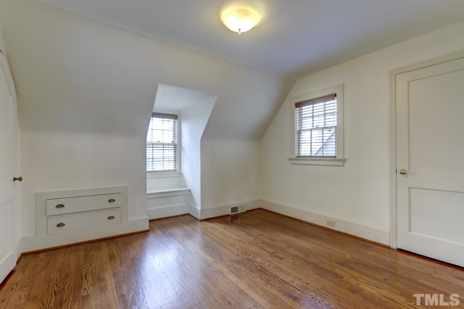 2601 London Drive Raleigh, NC 27608 - Photo 24 of 30 an empty room with wooden floor and windows