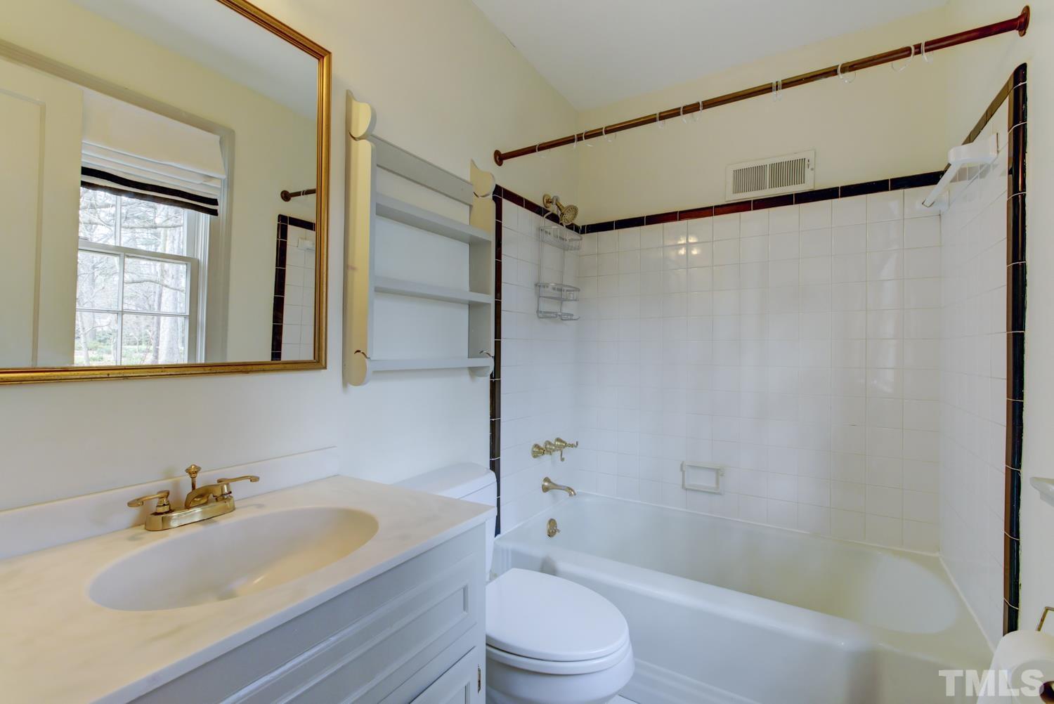 2601 London Drive Raleigh, NC 27608 - Photo 25 of 30 a bathroom with a sink toilet and shower
