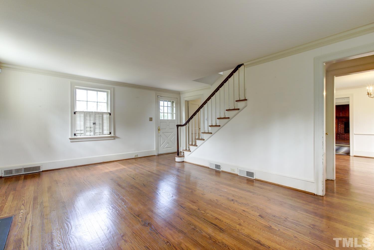 2601 London Drive Raleigh, NC 27608 - Photo 4 of 30 a view of an empty room with wooden floor and a window