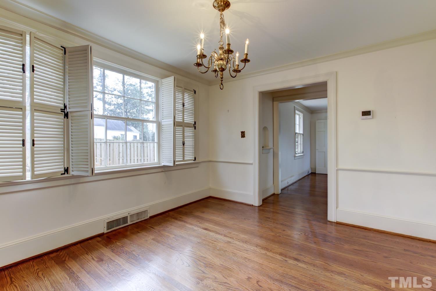 2601 London Drive Raleigh, NC 27608 - Photo 10 of 30 a view of an empty room with wooden floor and a window