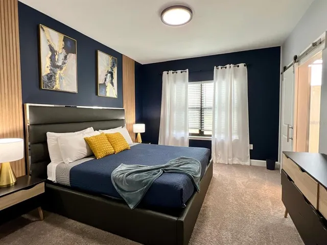 a bedroom with a large bed and a window