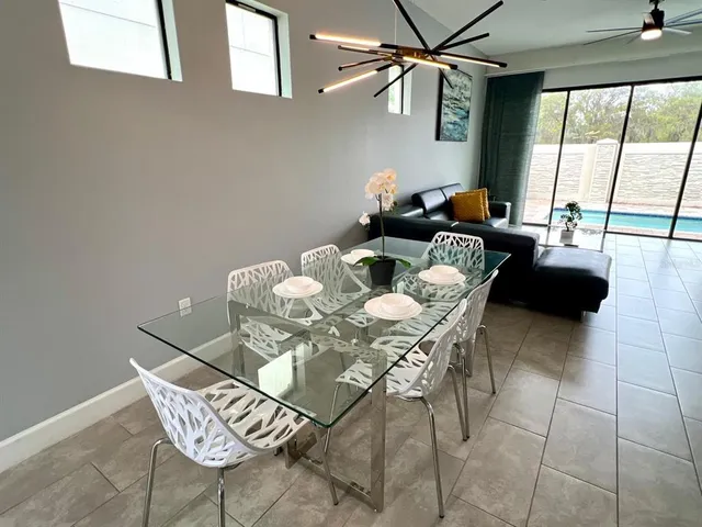 a dining room with furniture and a large window