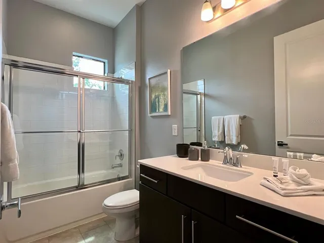 a bathroom with a double vanity sink mirror and toilet