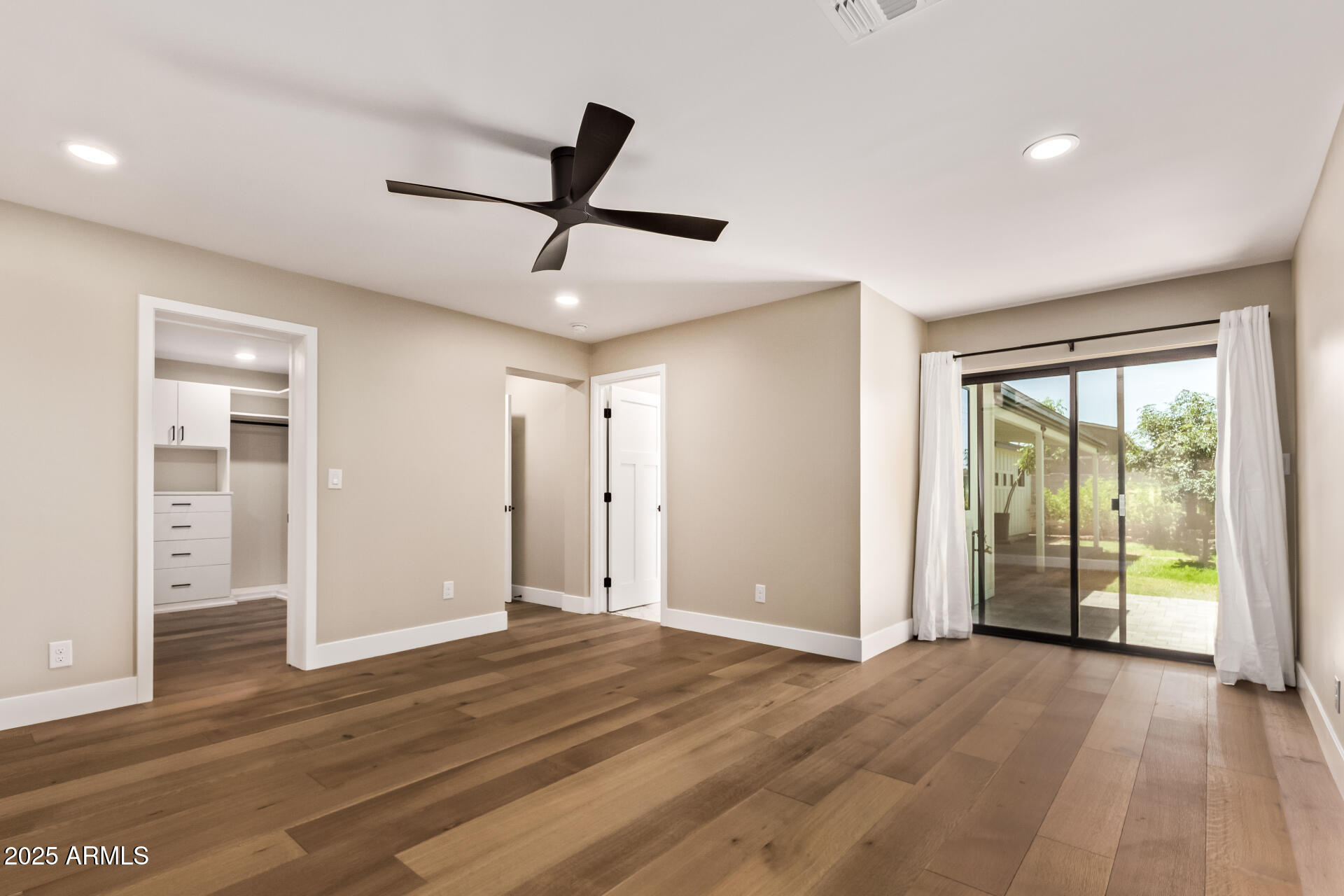 1540 West Lawrence Lane Phoenix, AZ 85021 - Photo 11 of 27 a view of an empty room with wooden floor and a window