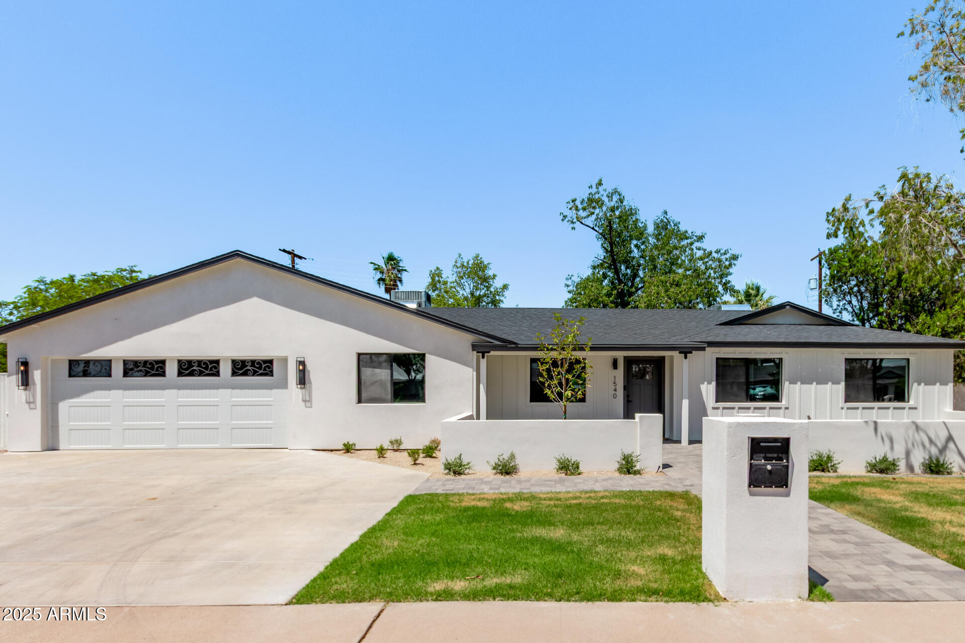 1540 West Lawrence Lane Phoenix, AZ 85021 - Photo 2 of 27 a front view of a house with a yard and garage