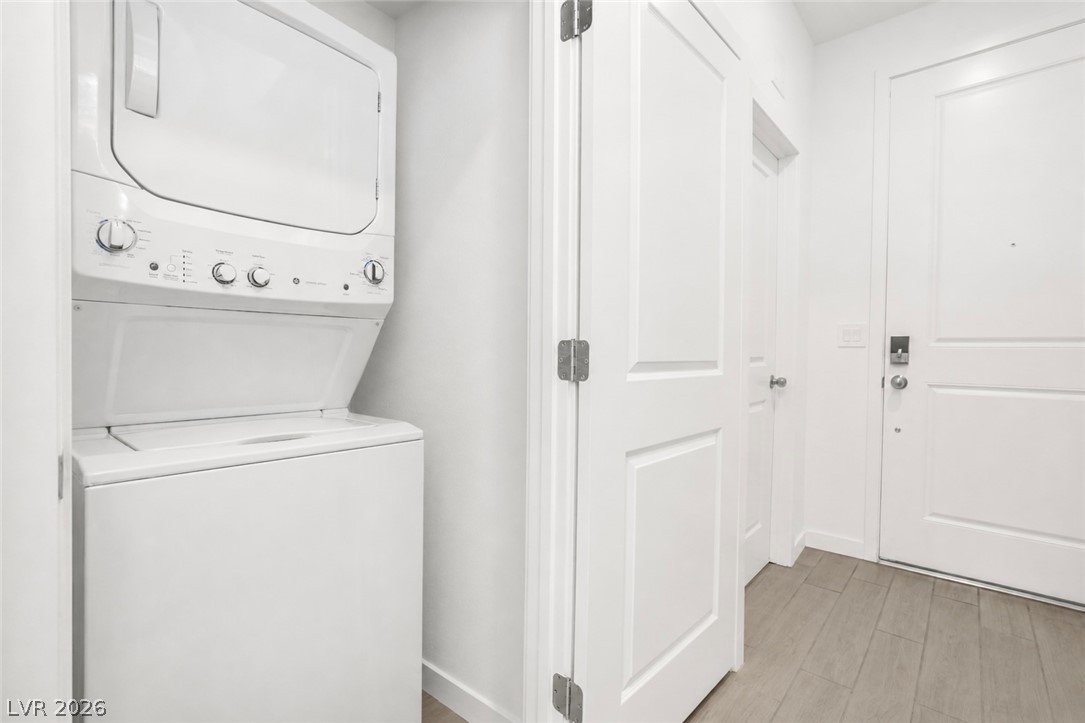 9398 Noble Fir Rdg Court Las Vegas, NV 89143 - Photo 25 of 36 A well-appointed laundry closet offers convenient, stacked appliances near the entry.
