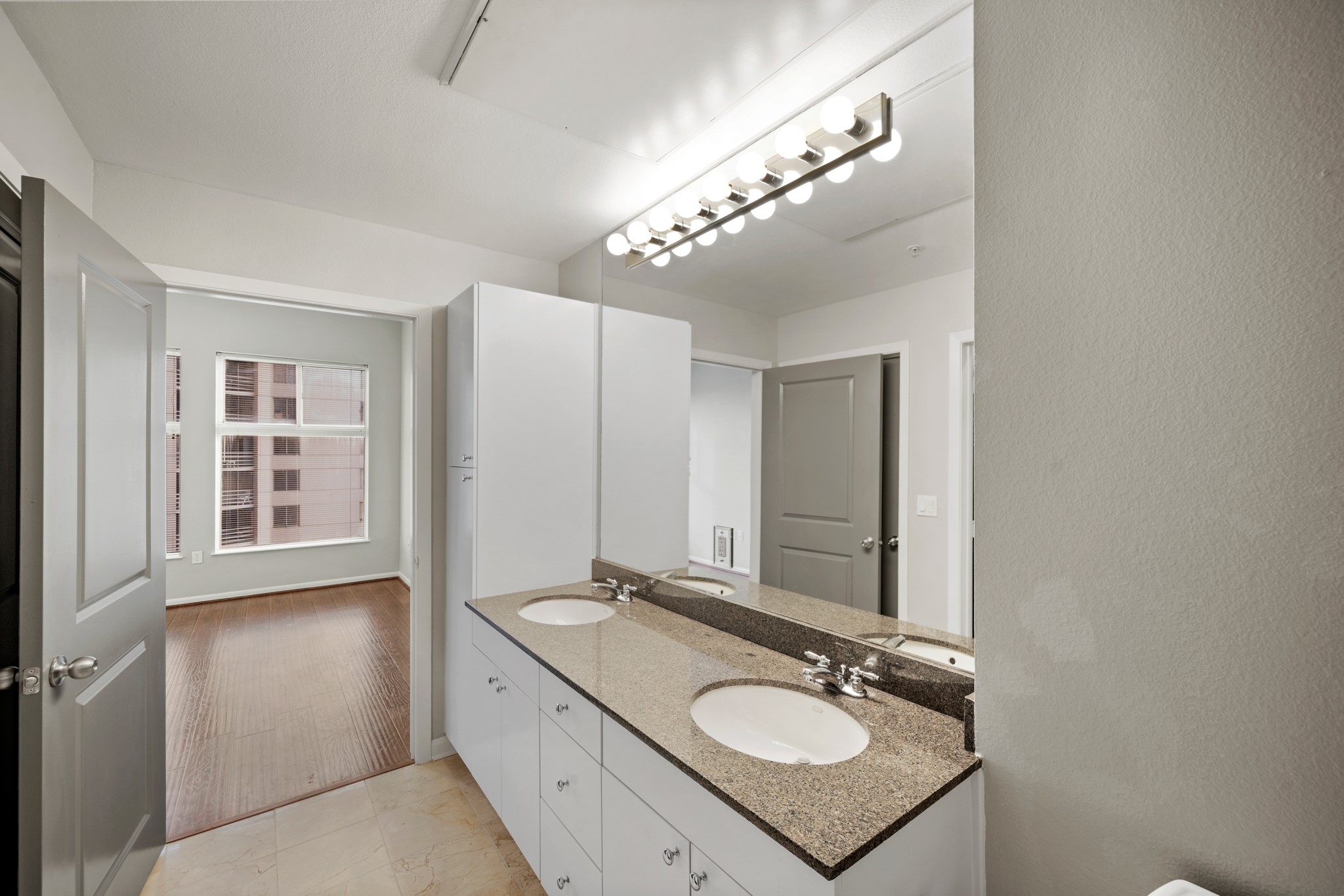 3505 Sage Road, Unit 1004 Houston, TX 77056 - Photo 14 of 17 a en suite bathroom with a double vanity sink a mirror and a shower
