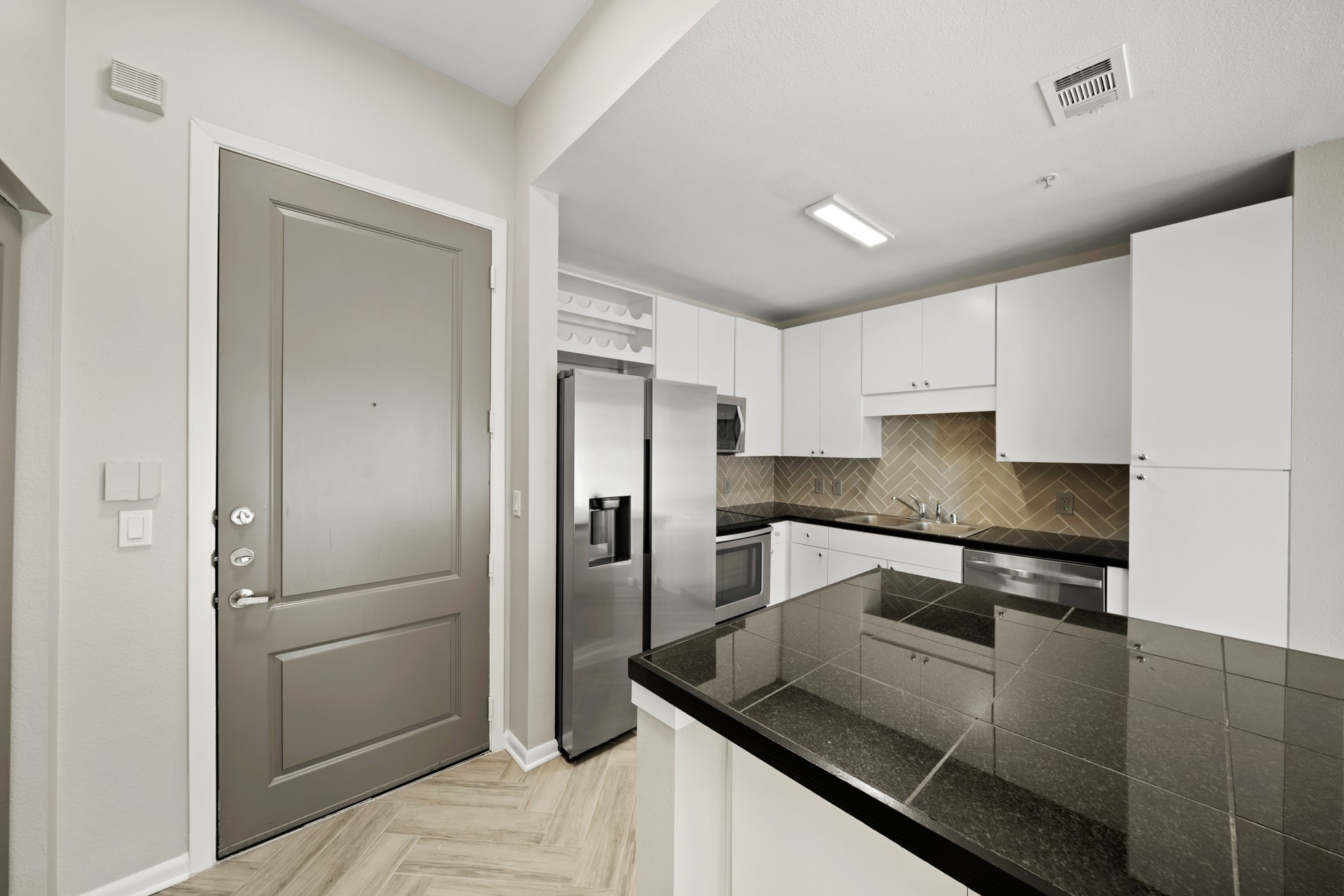 3505 Sage Road, Unit 1004 Houston, TX 77056 - Photo 2 of 17 a kitchen with stainless steel appliances granite countertop a refrigerator and a sink