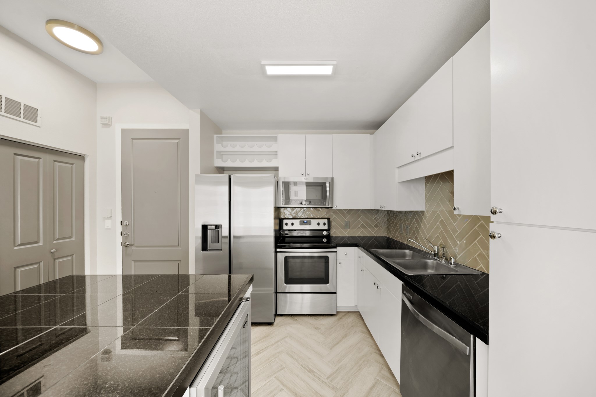 3505 Sage Road, Unit 1004 Houston, TX 77056 - Photo 3 of 17 a kitchen with granite countertop a refrigerator and a sink
