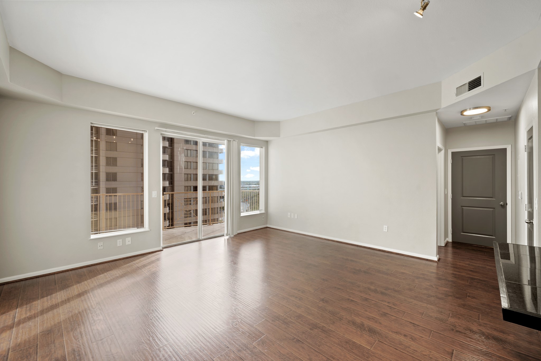 3505 Sage Road, Unit 1004 Houston, TX 77056 - Photo 4 of 17 wooden floor in an empty room with a window