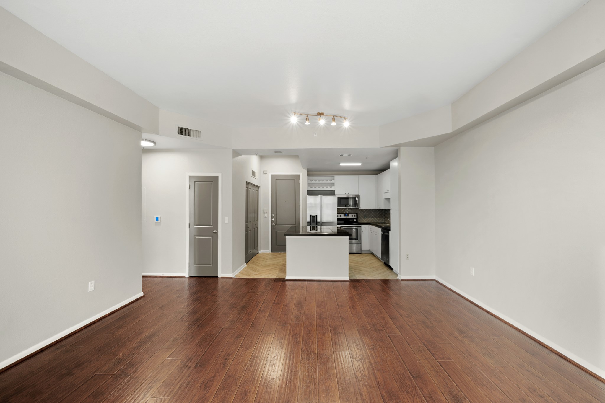 3505 Sage Road, Unit 1004 Houston, TX 77056 - Photo 9 of 17 a view of a kitchen with a sink and a refrigerator
