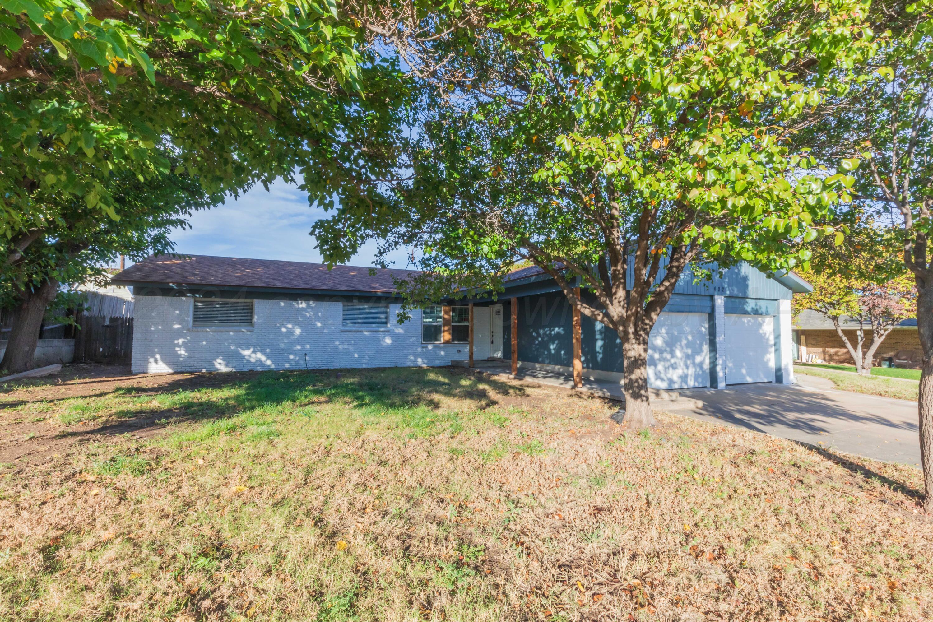 402 Beech Street Borger, TX 79007 - Photo 2 of 41 a house with a large tree in front of it