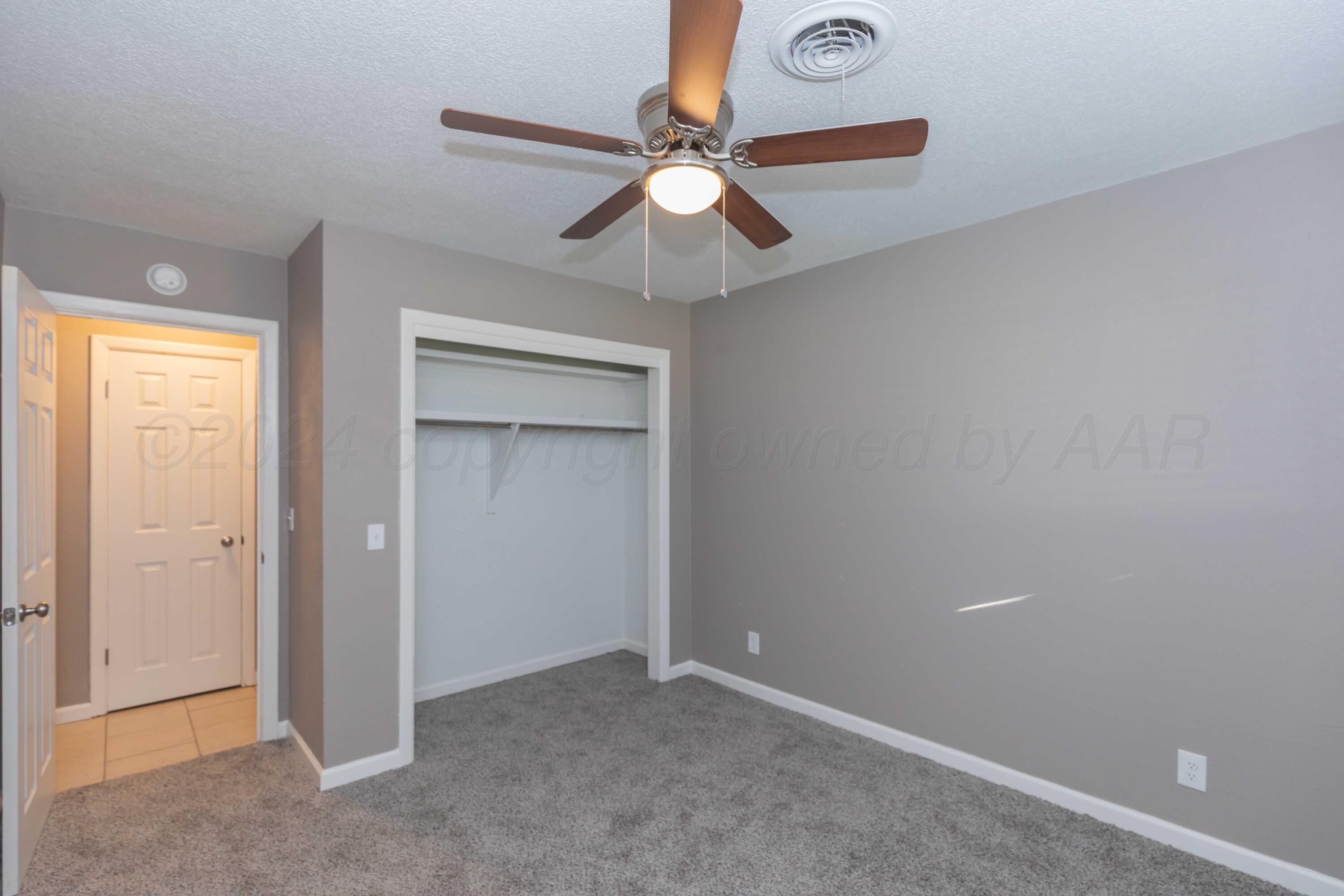 402 Beech Street Borger, TX 79007 - Photo 27 of 41 an empty room with closet and a chandelier fan