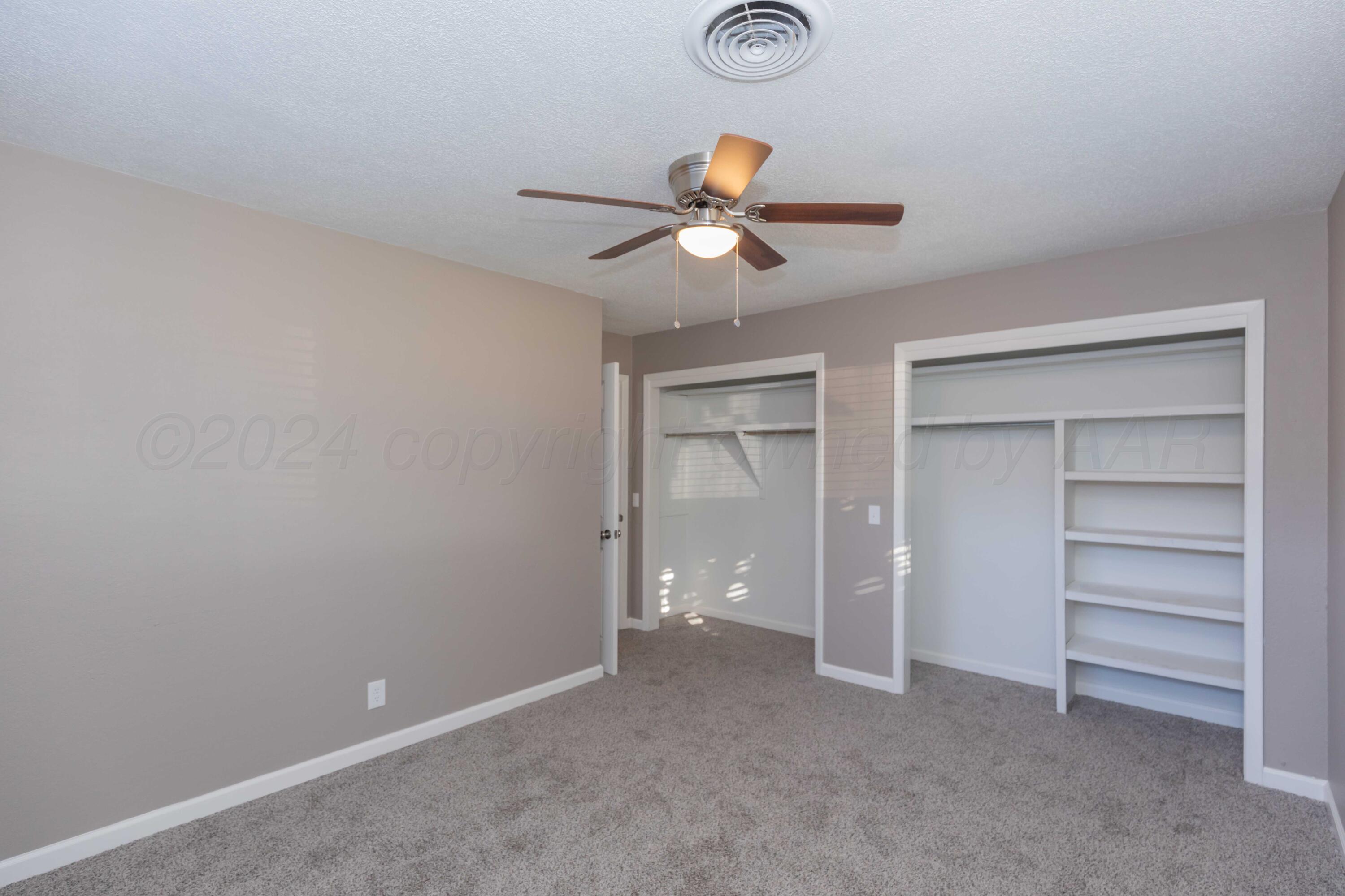 402 Beech Street Borger, TX 79007 - Photo 30 of 41 a view of an empty room with a ceiling fan