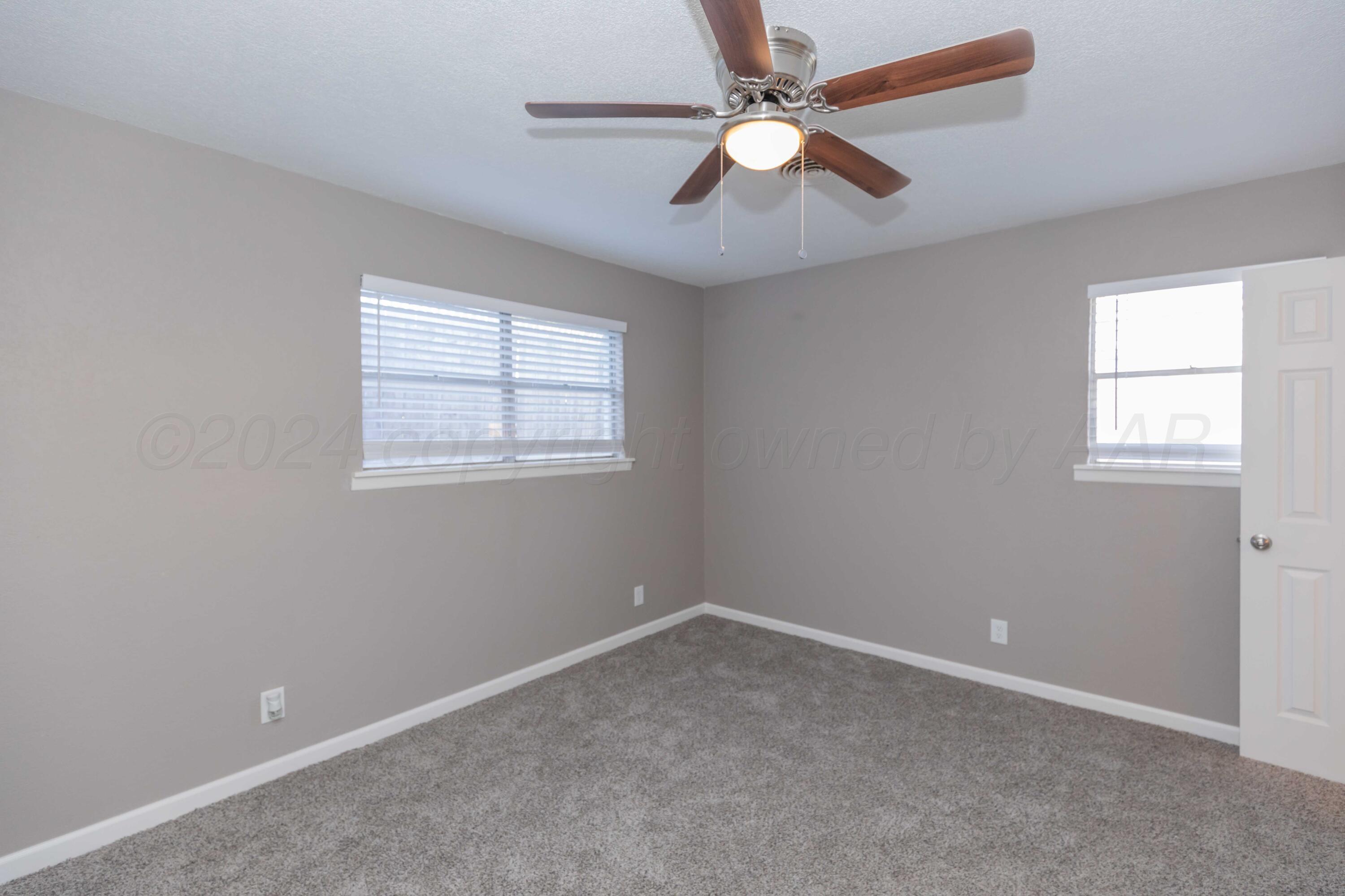 402 Beech Street Borger, TX 79007 - Photo 35 of 41 an empty room with a window and a fan