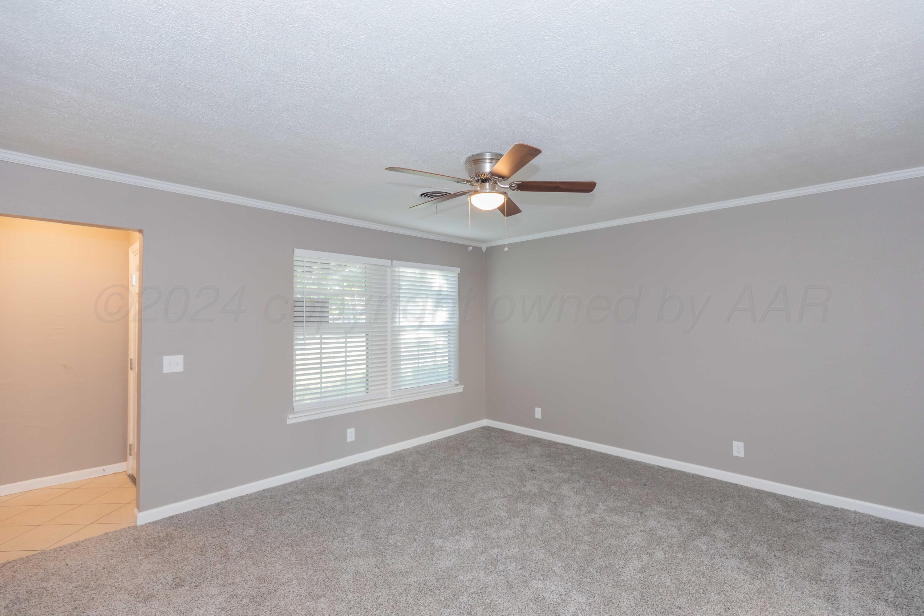 402 Beech Street Borger, TX 79007 - Photo 6 of 41 an empty room with a window