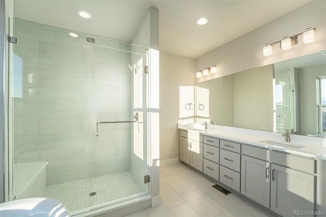 a bathroom with a shower sink and mirror