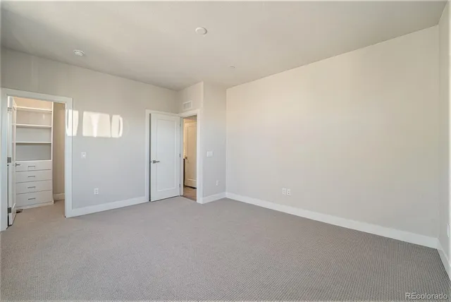 an empty room with closet area