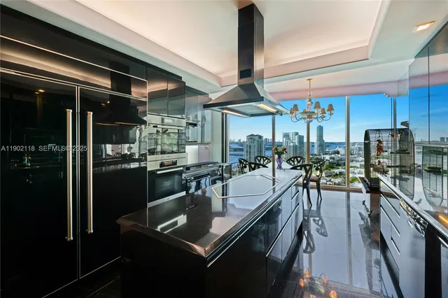 a view of a dining room with furniture a chandelier and wooden floor