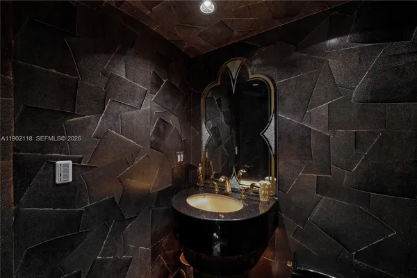 a kitchen with a table chairs a barbeque and potted plant