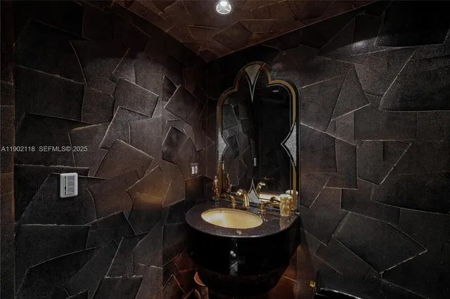 a kitchen with a table chairs a barbeque and potted plant