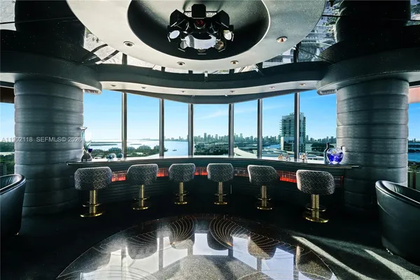 a picture of a living room with a floor to ceiling window and outdoor seating