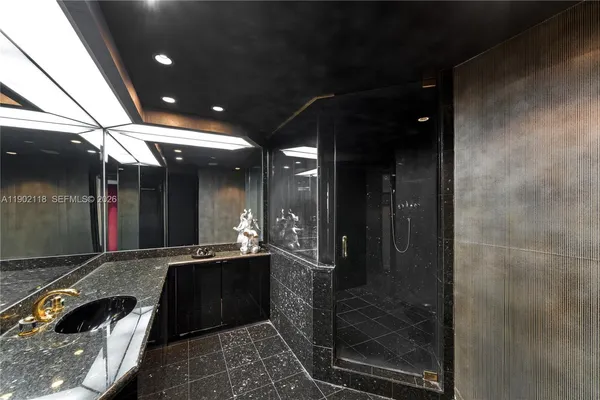 a bedroom with a bed and a dresser next to a window