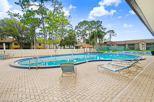 a swimming pool with outdoor seating and yard