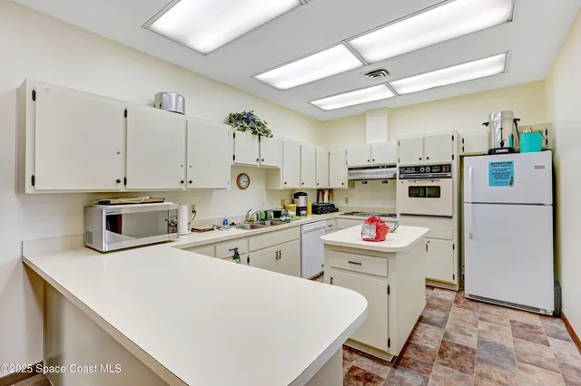 a view of a dining room with furniture water view and windows