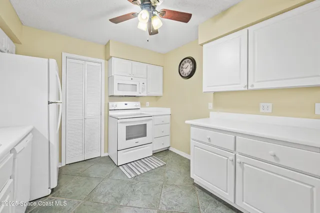 a kitchen with cabinets stainless steel appliances and a counter space