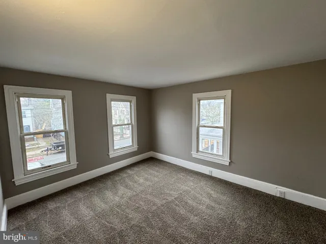a view of an empty room with windows