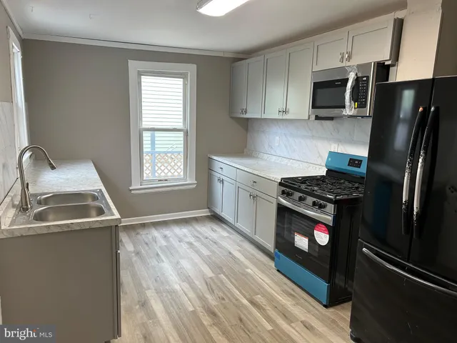 a kitchen with a refrigerator stove and microwave
