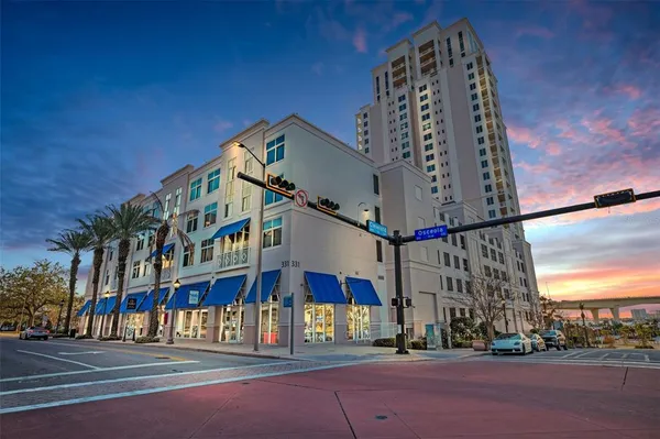 a view of a tall building next to a road