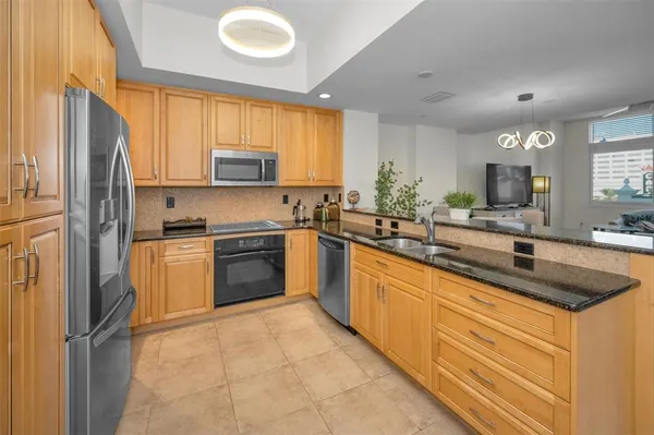 a bedroom with a bed and a flat tv screen on dresser