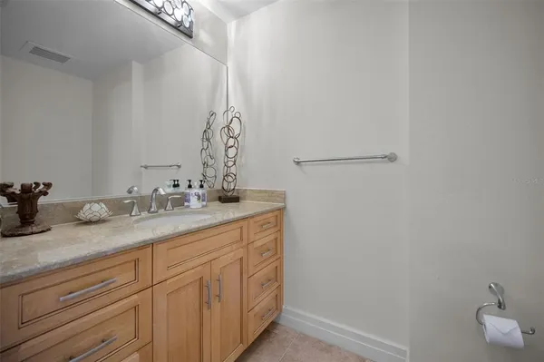 a bathroom with a granite countertop sink a mirror and a shower
