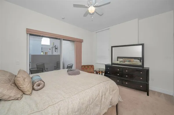 a room with a bed and a mirror on dresser