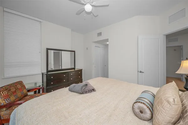 a bedroom with a bed and a lamp