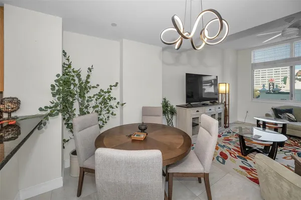 a kitchen with stainless steel appliances granite countertop a refrigerator a stove and a sink with wooden cabinets