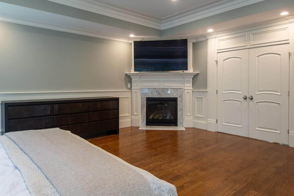49 Bristol Road Wellesley, MA 02481 - Photo 16 of 30 a bedroom with a bed and a fireplace