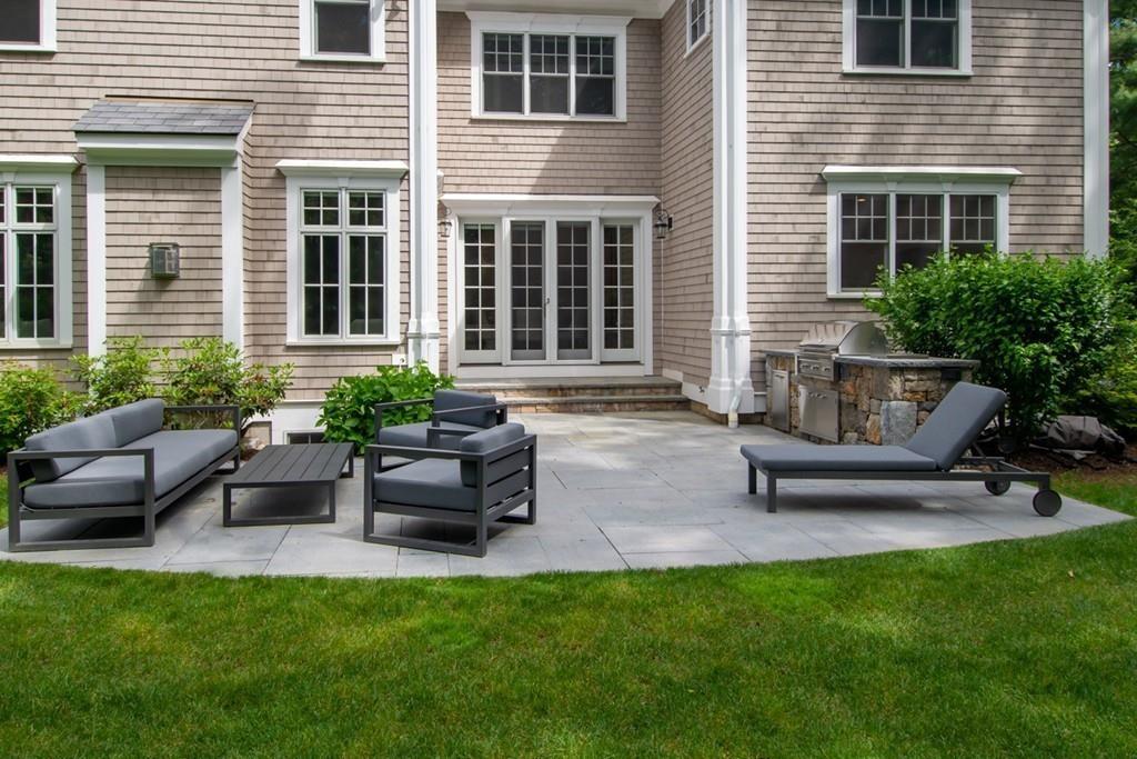 49 Bristol Road Wellesley, MA 02481 - Photo 26 of 30 a view of a patio with couches chairs and a yard