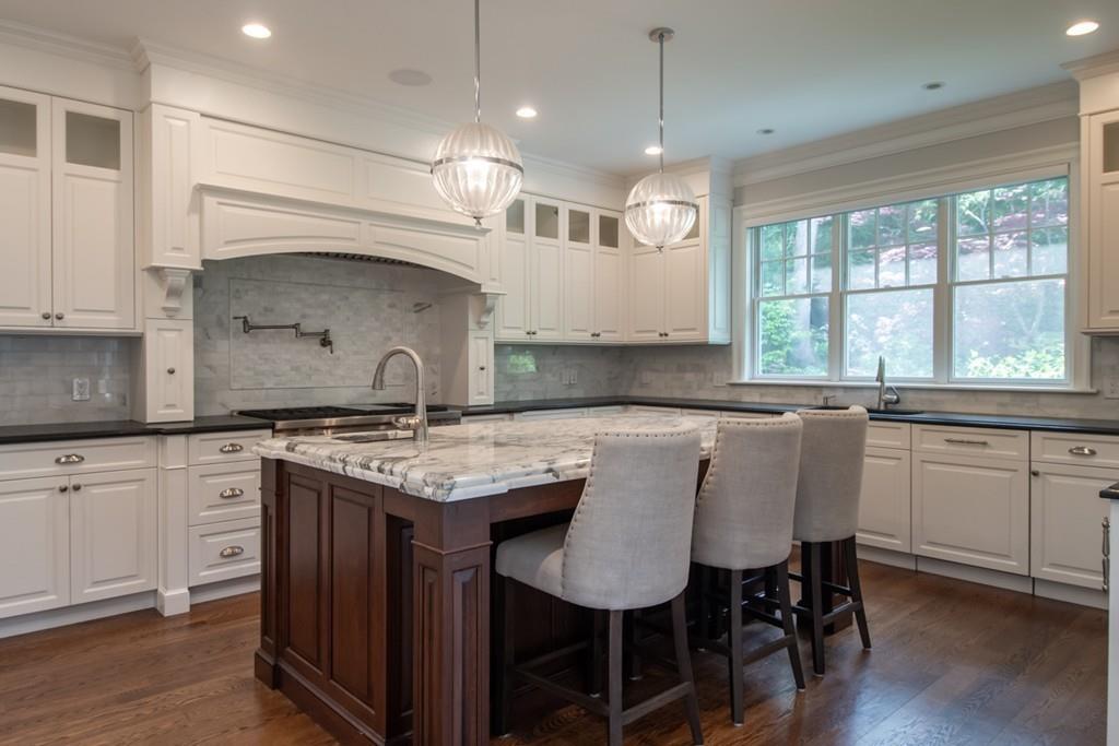 49 Bristol Road Wellesley, MA 02481 - Photo 3 of 30 a kitchen with granite countertop a sink a center island a stove cabinets and chair