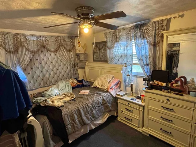 a bedroom with a bed and a mirror