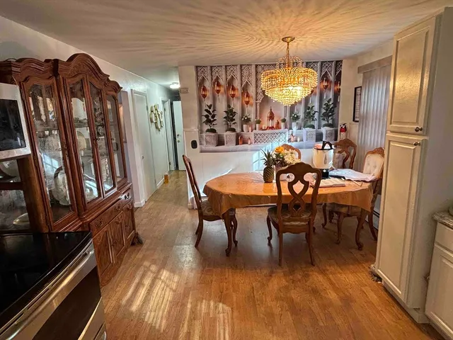 a dining room with furniture a rug and wooden floor
