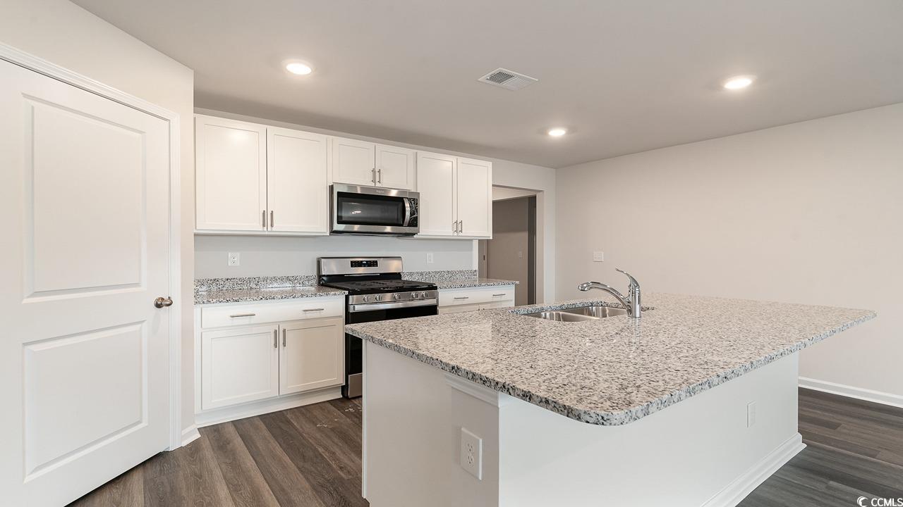 6059 Fuller Rdg Court Conway, SC 29526 - Photo 10 of 23 Kitchen featuring white cabinetry, an island with