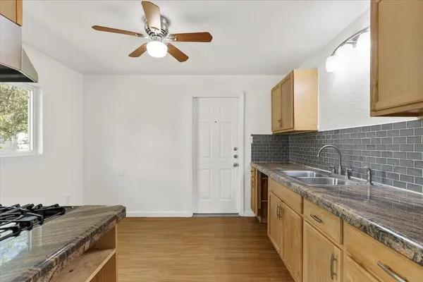 a kitchen with sink cabinets and window