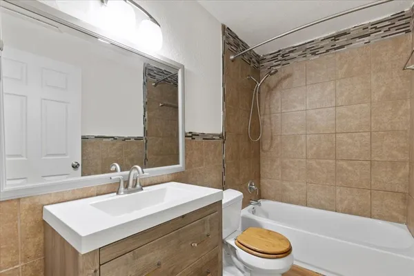 a bathroom with a sink a toilet and a bathtub