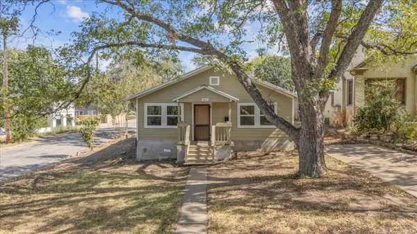 a front view of a house with yard covered in snow