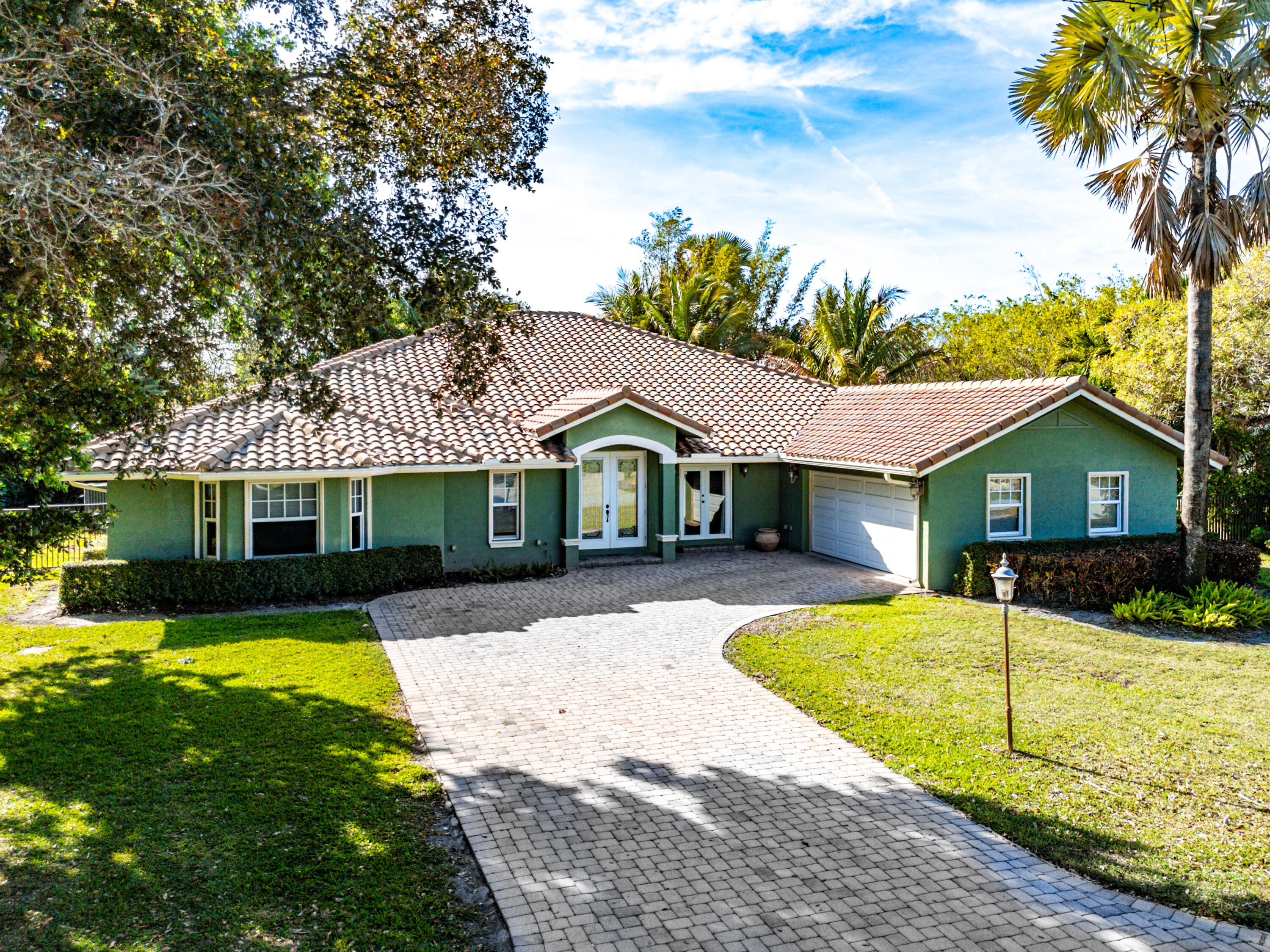 10295 St Andrews Road Boynton Beach, FL 33436 - Photo 1 of 43 a front view of a house with yard patio and swimming pool