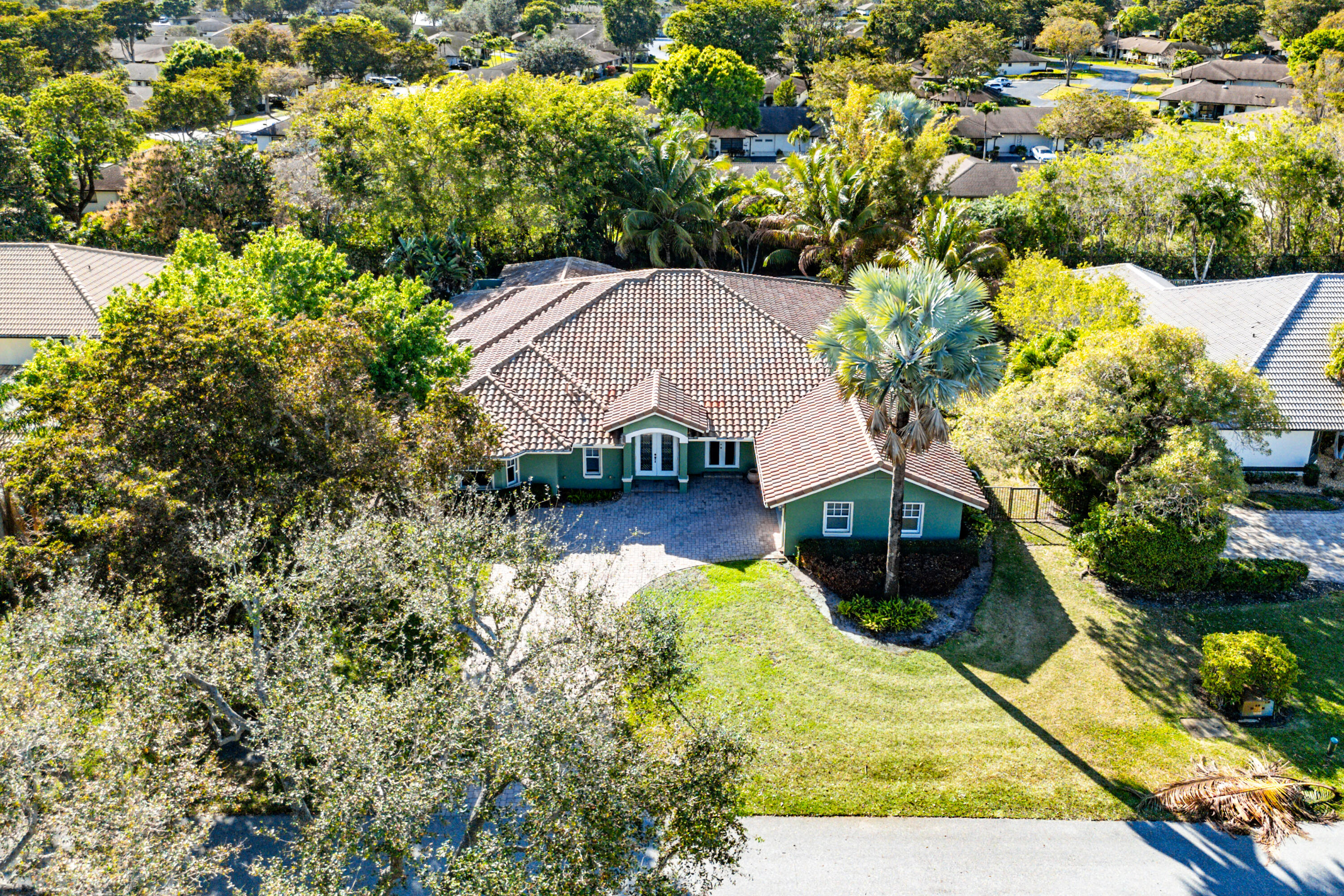 10295 St Andrews Road Boynton Beach, FL 33436 - Photo 2 of 43 a view of house with swimming pool and garden